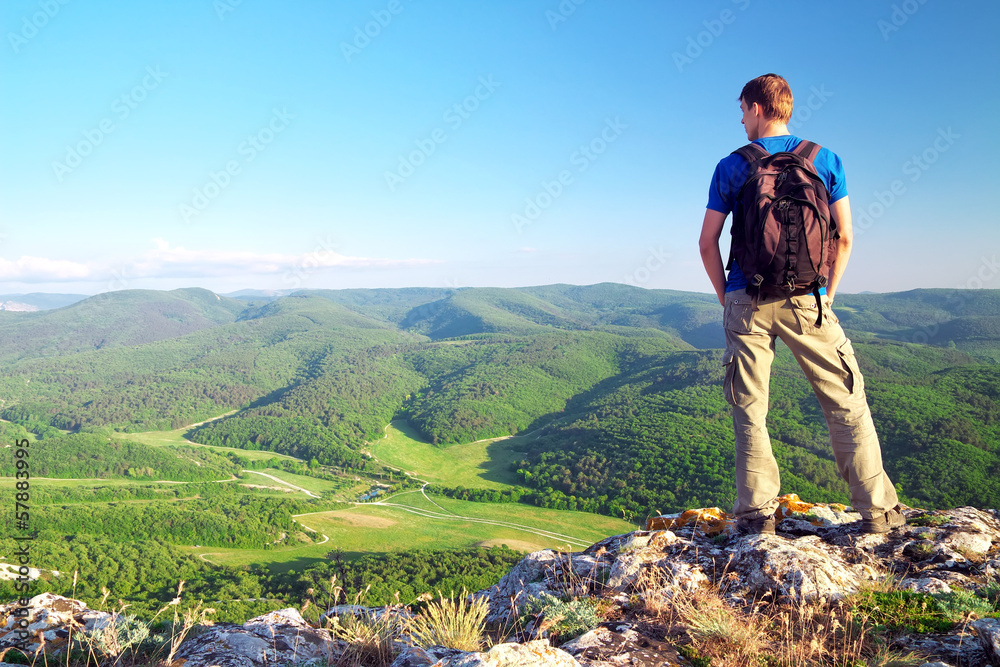 Man on top of mountain. Tourism concept