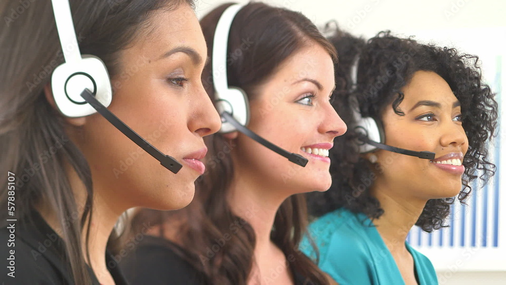 Three customer service representatives talking on headsets