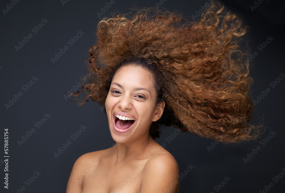 Φωτογραφία Portrait of an attractive young woman laughing with hair blowing
