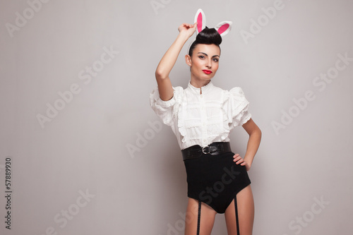 Sexy pinup model posing in vintage bunny costume