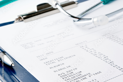 Blood test results in a clipboard with stethoscope