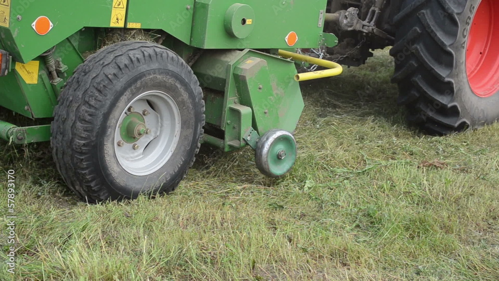 Follow special tractor equipment collecting hay in field Follow special tractor equipment collecting hay in field