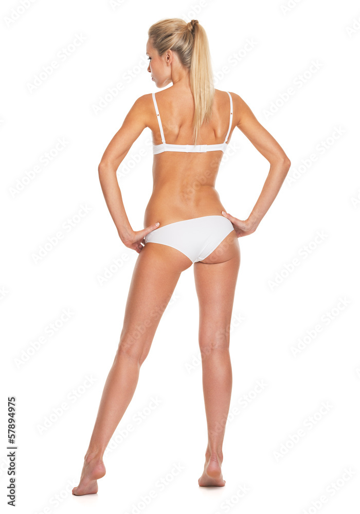 Full length portrait of young woman in lingerie . rear view Full length portrait of young woman in lingerie . rear view