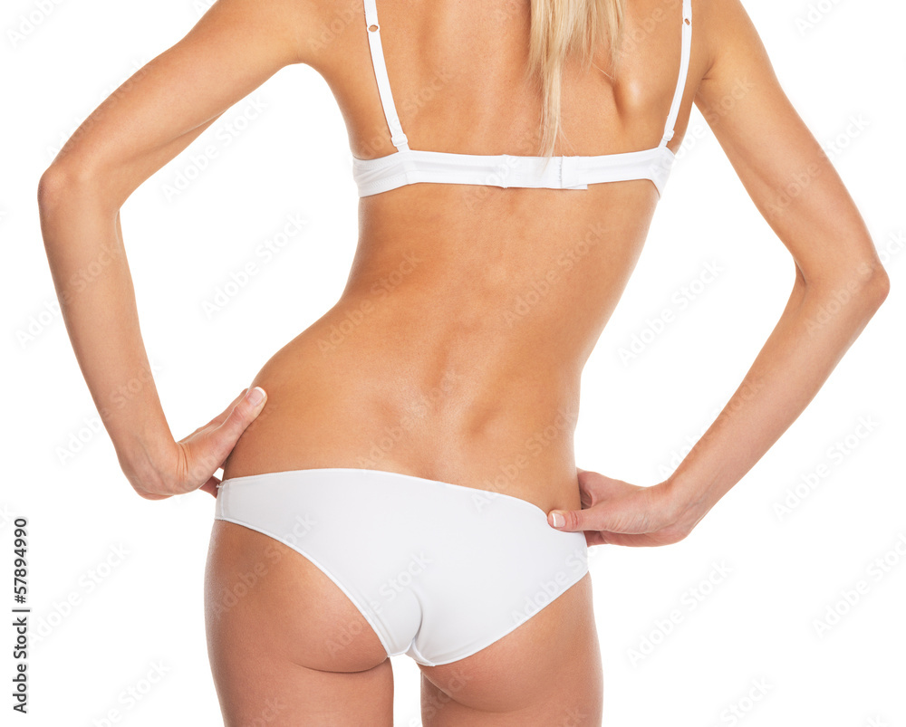 Closeup on torso of young woman in lingerie . rear view Closeup on torso of young woman in lingerie . rear view