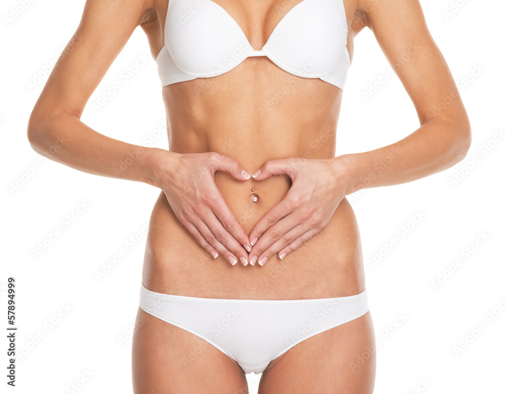 Closeup on woman in lingerie put hands on stomach in form heart