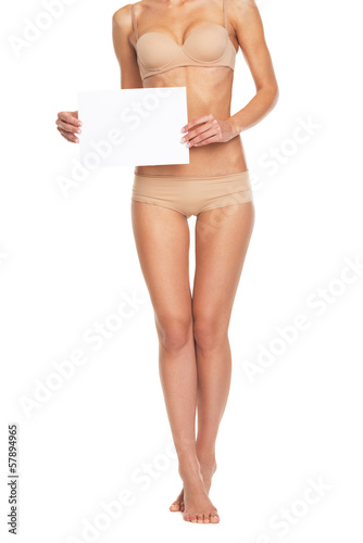 Closeup on young woman in lingerie showing blank paper sheet