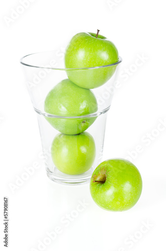 Fresh green apples in glass isolated on white