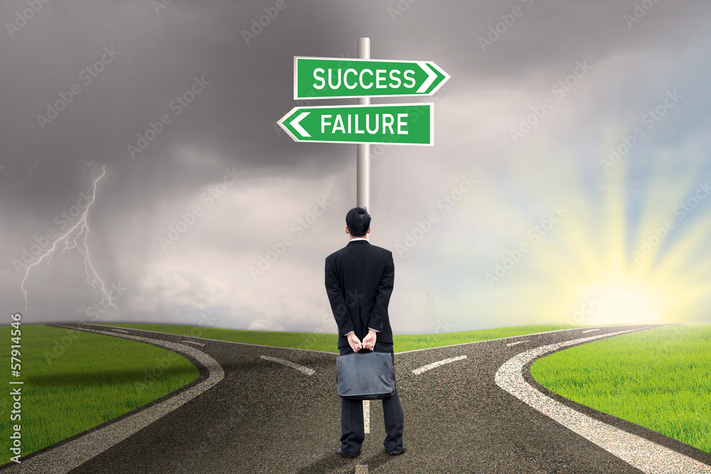 Businessman with briefcase looking at success or failure Businessman with briefcase looking at success or failure