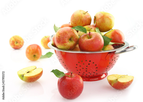 Apples in colander  isolated on white