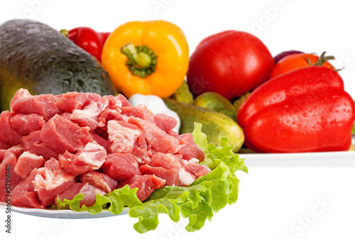 Fresh raw meat and vegetables isolated on white