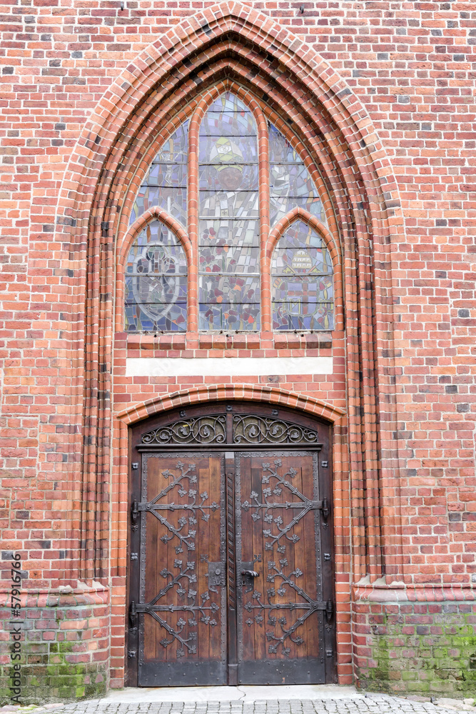 Old stylish door in Polish cathedrak in Koszalin. Gothic style.