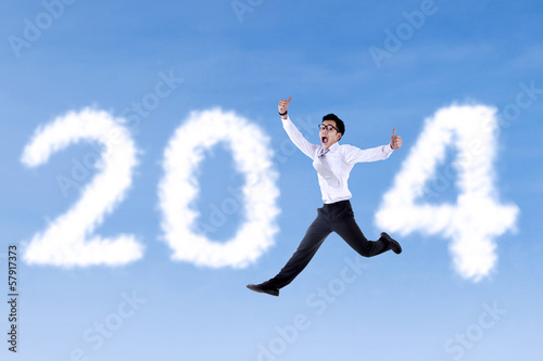 Excited businessman jumping with 2014
