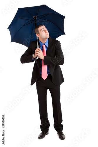 Businessman under an umbrella isolated on white