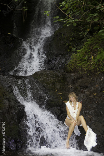 blond woman in a waterfall