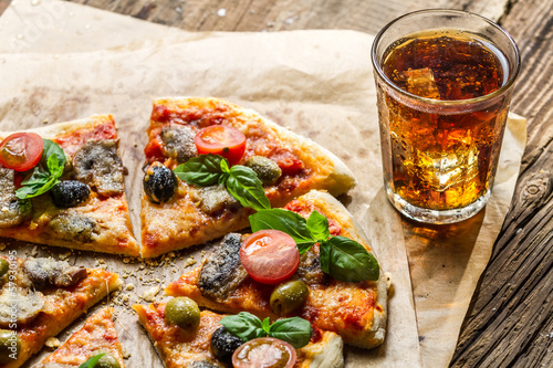 Baked pizza and served with cold drink