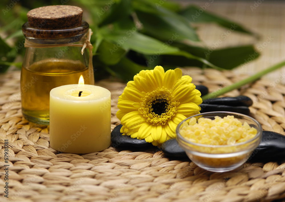 candle and daisies flower and bamboo leaf on wicker mat candle and daisies flower and bamboo leaf on wicker mat