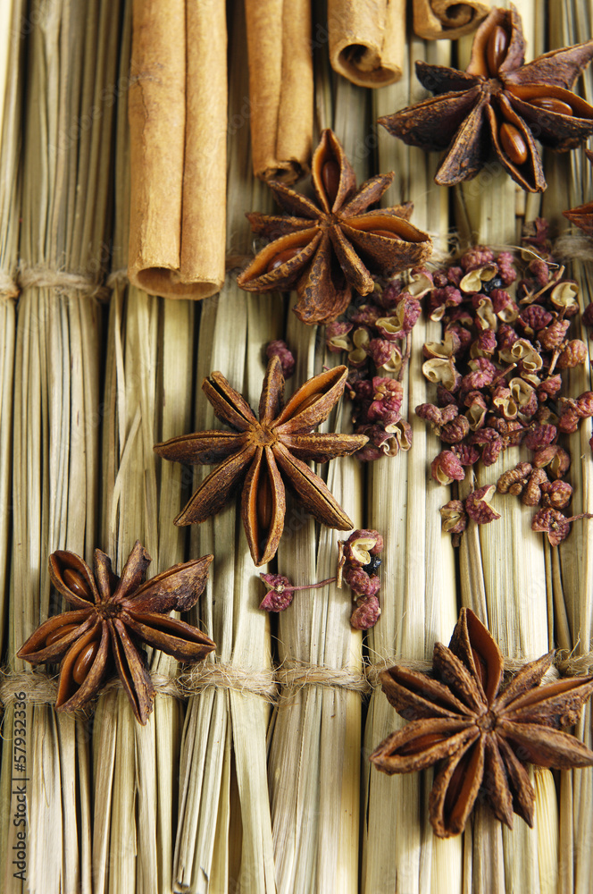 Pile of star anise and cinnamon sticks on straw