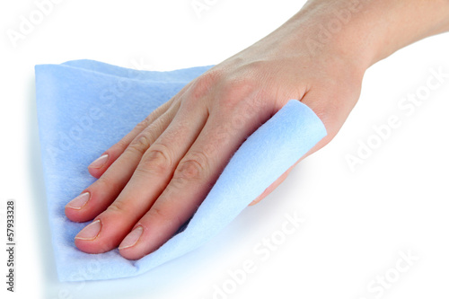 Hand wiping surface with blue rag isolated on white