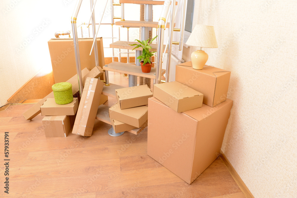 Stack of cartons near stairs: moving house concept Stack of cartons near stairs: moving house concept