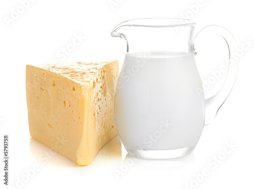 Big piece of cheese, glass jug with milk