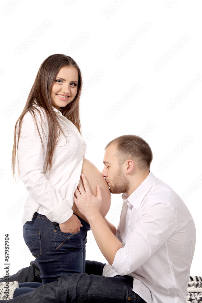 Husband is kissing stomach of pregnant woman Husband is kissing stomach of pregnant woman