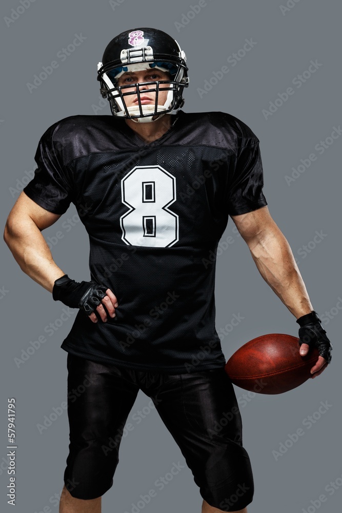 American football player wearing helmet and protective armour American football player wearing helmet and protective armour