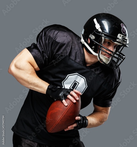 American football player wearing helmet and protective armour photo