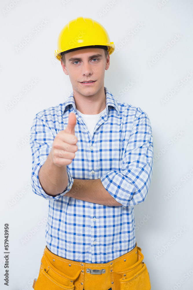 Handyman in yellow hard hat gesturing thumbs up