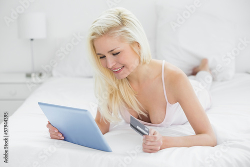 Free Download Casual young blond doing online shopping in bed - GFXLoad
