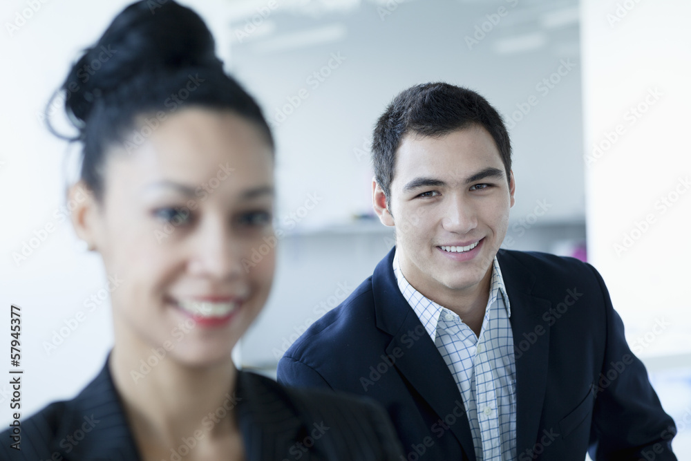 Portrait of two business people smiling and looking at the camera Portrait of two business people smiling and looking at the camera
