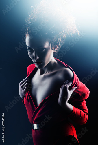 Flirting woman in red with curly hair