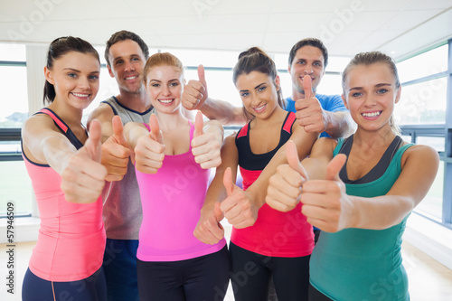Portrait of fitness class gesturing thumbs up