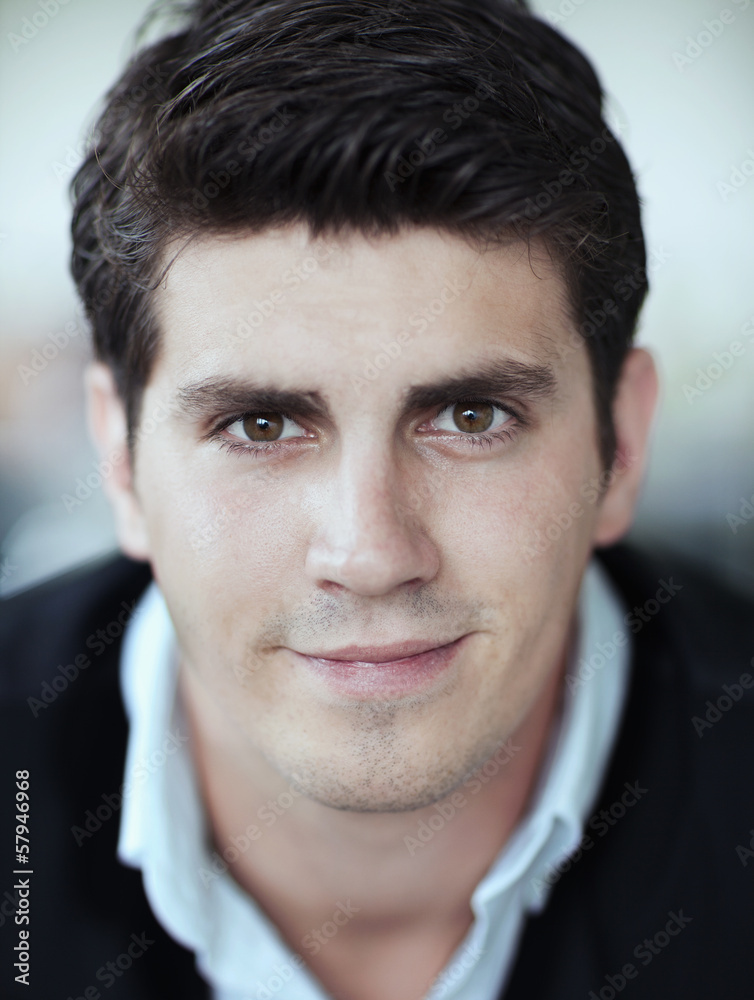 Fototapeta premium Portrait of smiling businessman in the office, close-up