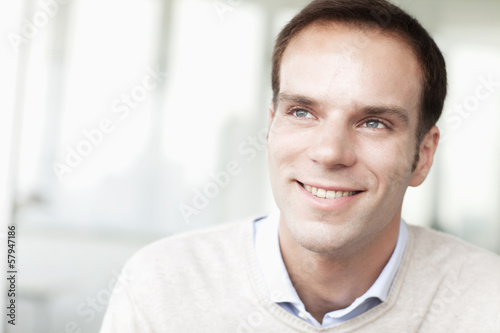 Portrait of smiling businessman in casual clothing looking away
