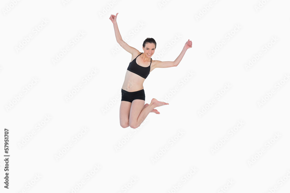 Full length of a sporty young woman jumping