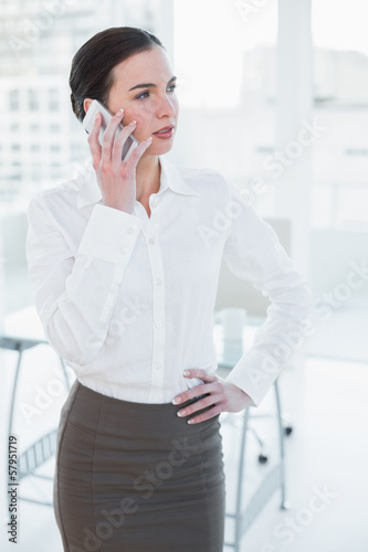 Elegant businesswoman using mobile phone in office