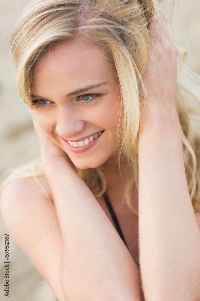 Smiling relaxed young blond looking away at beach Smiling relaxed young blond looking away at beach