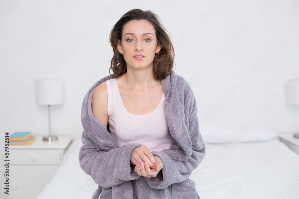 Beautiful young woman in bathrobe sitting in bed Beautiful young woman in bathrobe sitting in bed