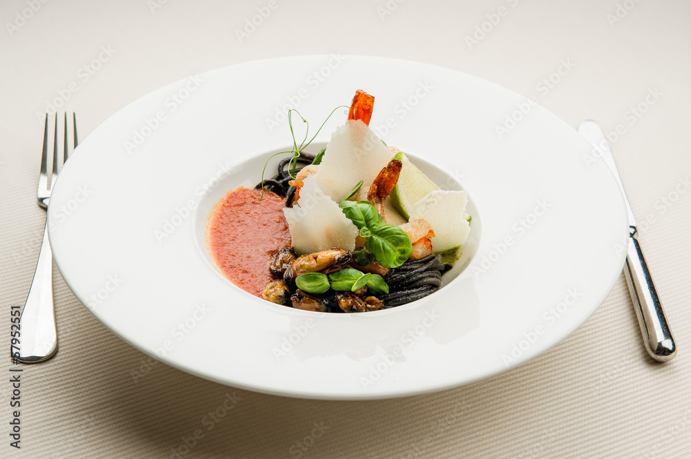 Black spaghetti with seafood,parmesan and tomato sauce Black spaghetti with seafood,parmesan and tomato sauce