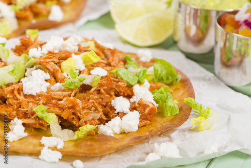 Tostadas - Mexican crispy tortilla with chicken tinga and cotija photo
