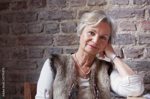 best ager women looking thoughtful out of window