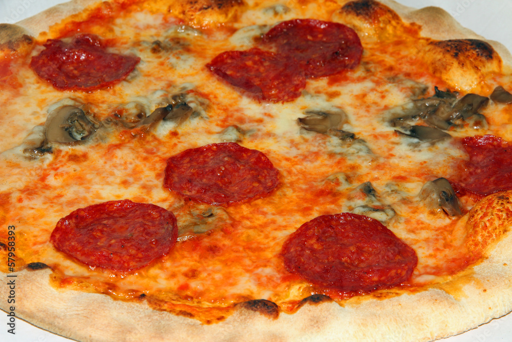 tasty pizza with pepperoni and mushrooms and mozzarella