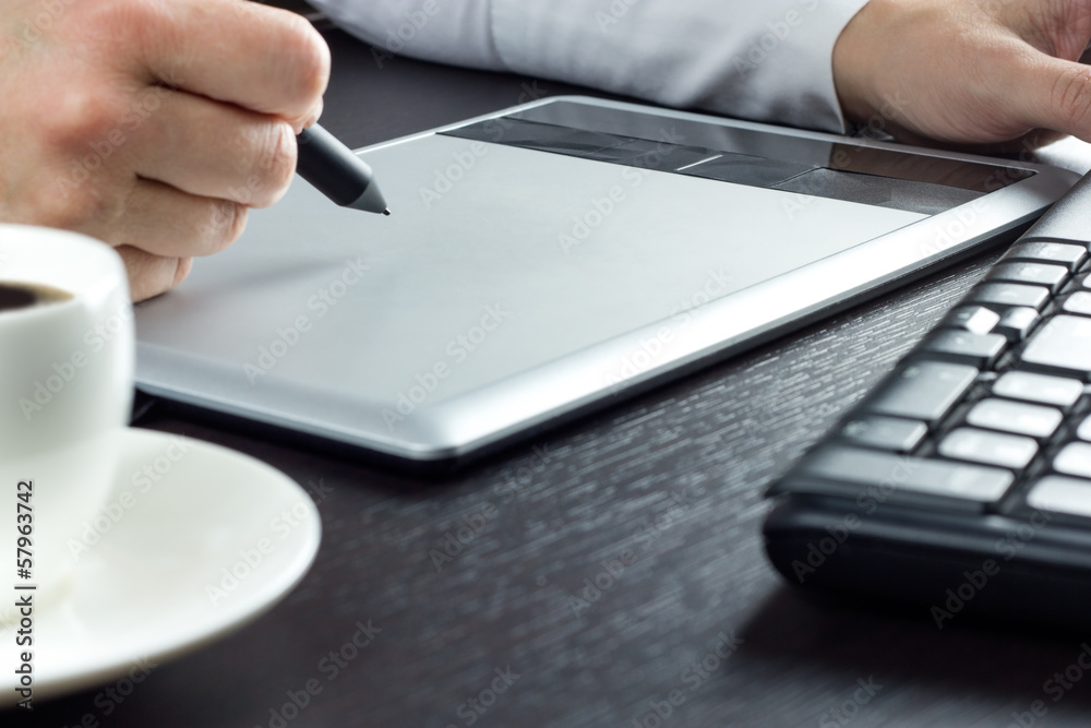 Close-up of hands drawing on graphic tablet