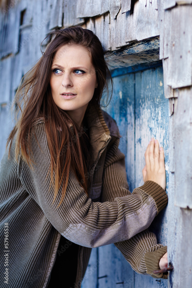 Fototapeta premium Scared woman pushing into a door