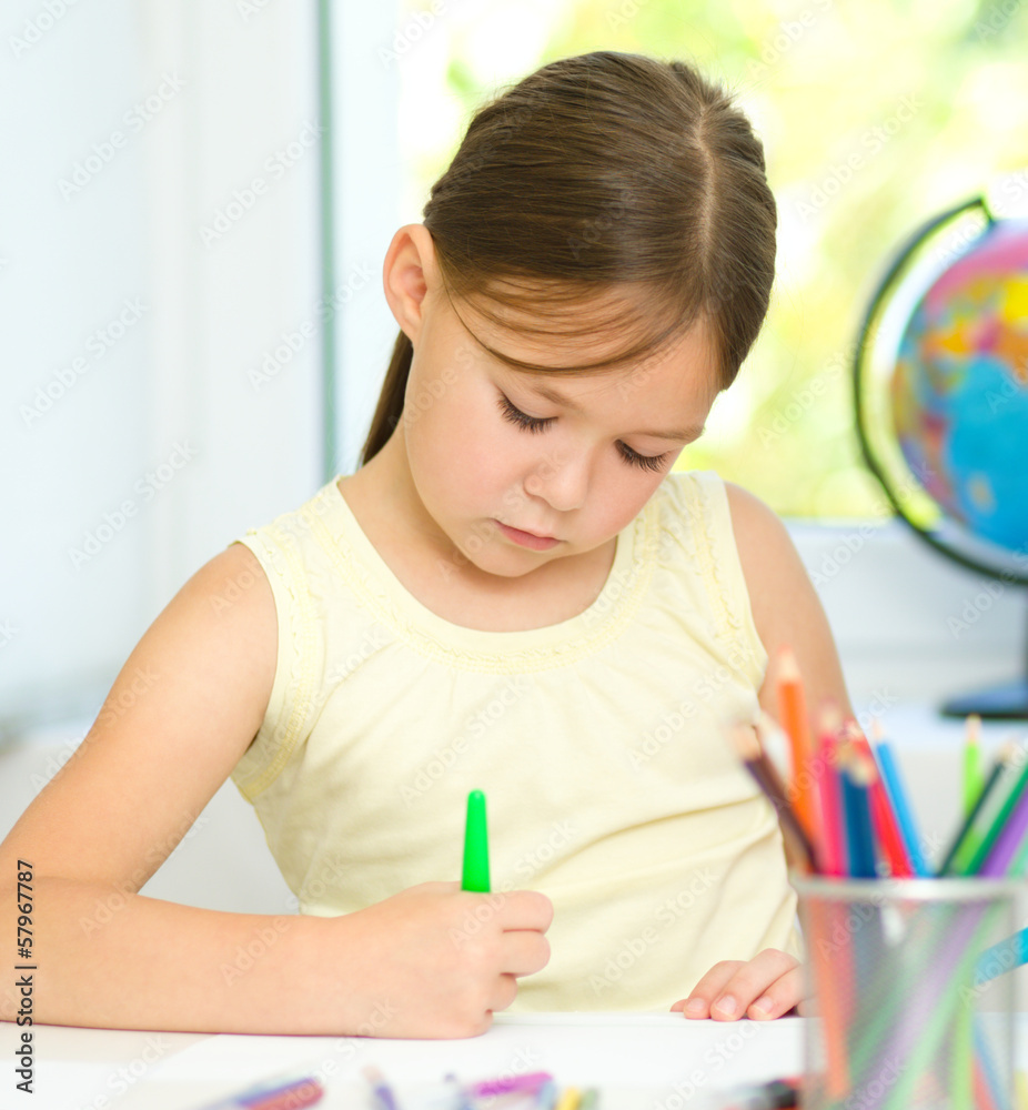 Cute cheerful child drawing using felt-tip pen Cute cheerful child drawing using felt-tip pen