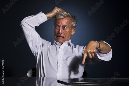Принти на полотні Upset frustrated senior man pointing at his tablet