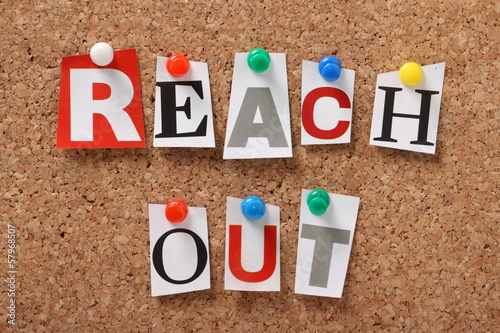 The phrase Reach Out on a cork notice board