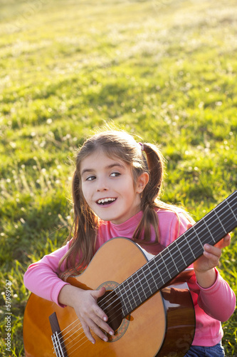 happy child playing guitar