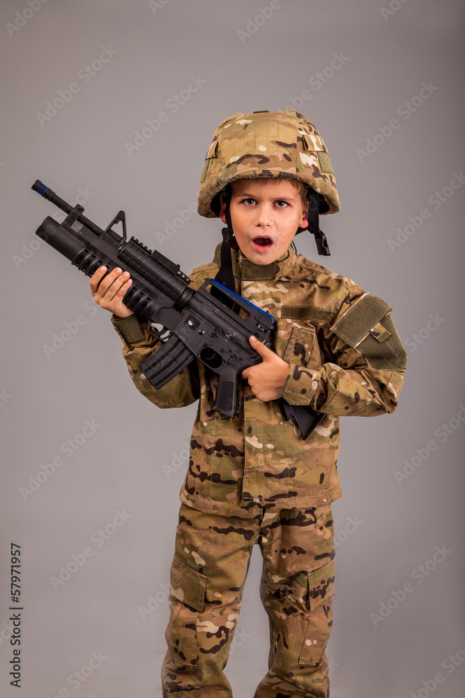 Young boy dressed like a soldier with rifle Young boy dressed like a soldier with rifle