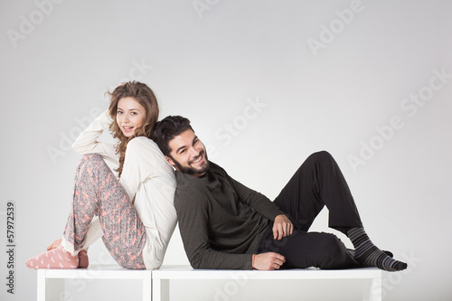 Happy couple in pyjama posing in the studio